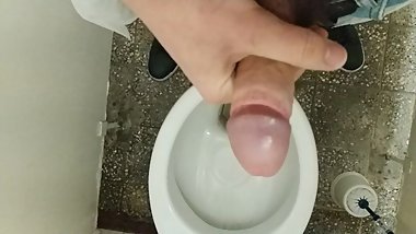 Jerking off in a public toilet