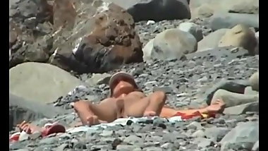 Young neighbor on the nudist beach. While shy